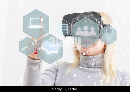 Young woman touch virtual hologram with non-fungible token hud, lines and art image icons. Glowing lines and blocks with nft symbol. Concept of Stock Photo