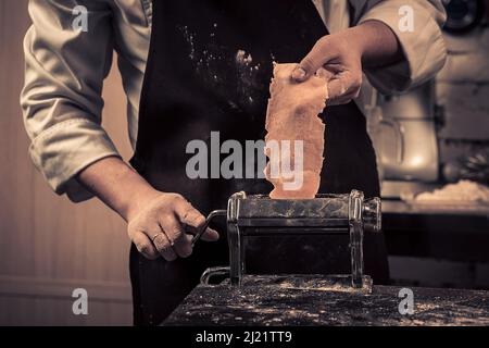 The chef makes fresh spaghetti from scratch. Stock Photo