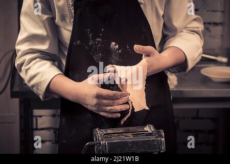 The chef makes fresh spaghetti from scratch. Stock Photo