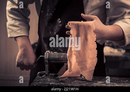 The chef makes fresh spaghetti from scratch. Stock Photo