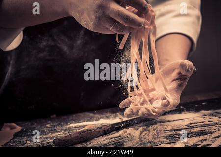 The chef makes fresh spaghetti from scratch. Stock Photo