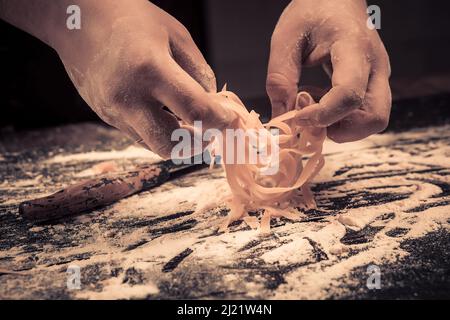 The chef makes fresh spaghetti from scratch. Stock Photo
