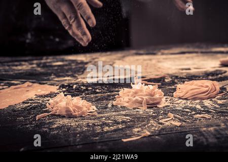 The chef makes fresh spaghetti from scratch. Stock Photo