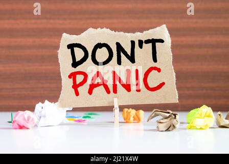 Word writing text Don t not Panic. Business concept for sudden strong feeling of fear prevents reasonable thought Clothespin holding blue paper note c Stock Photo