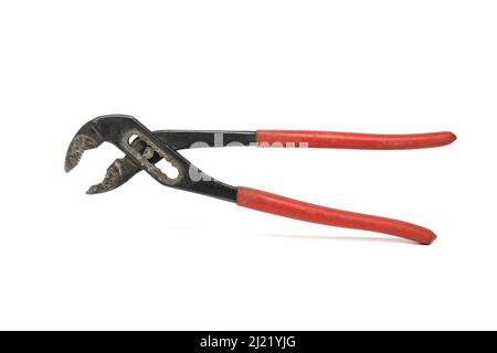 Close up of massive used old red and black professional variable adjustable pipe wrench on white background Stock Photo