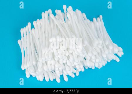 White cotton swabs on blue background Stock Photo