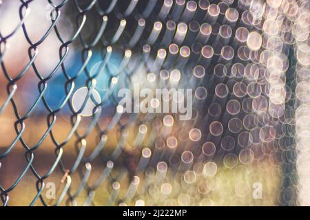 Old rusty metal wire mesh outdoor defocus background, blurred texture, soft focus vintage lens Stock Photo
