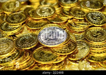 Golden bitcoin cryptocurrency on pile gold coins a lot of Stock Photo