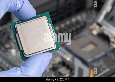 Plug in CPU microprocessor to motherboard socket. Technological background. Concept computers harware. Stock Photo