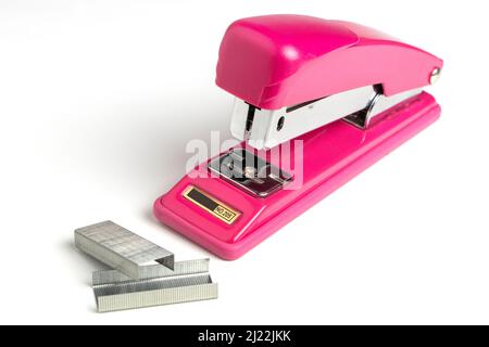 Stapler and metal staple concept over white background. Stock Photo