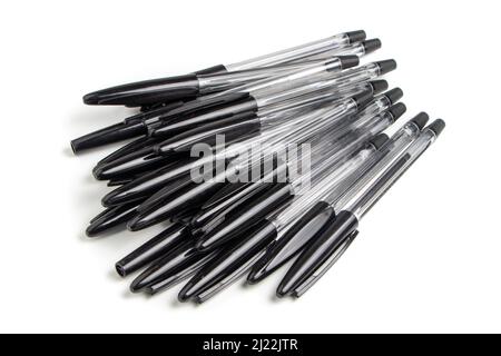 Lots of black ballpoint pens on a white background, multi-colored ballpoint pens. Stock Photo
