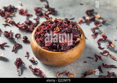 Raw Red Organic Dried Hibiscus Flower Tea in a Bowl Stock Photo
