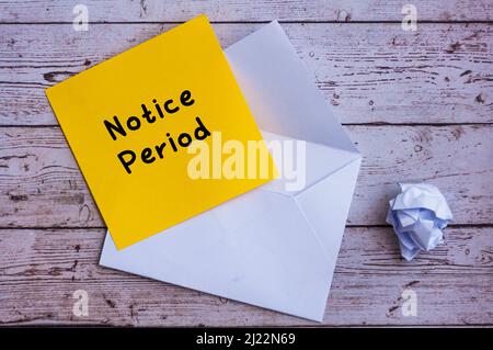 Notice period text on yellow notepad with envelope background. Employment concept Stock Photo