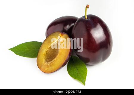Isolated plums. Whole and a half of blue plum fruit isolated on white background Stock Photo
