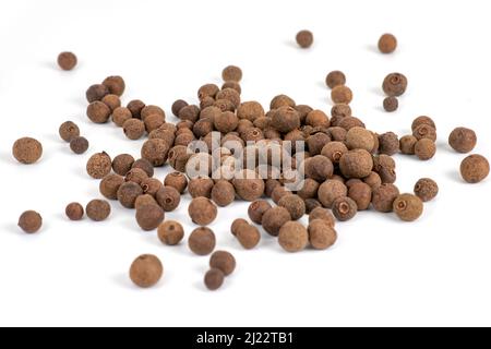 Pile of dried allspice fruits spices isolated on white background. Stock Photo