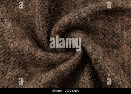 Twisted brown lambswool fabric with waves and curves. Wool material. felt texture Stock Photo