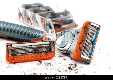 Shaving machine on a white background. Used razor blades with hair isolate Stock Photo