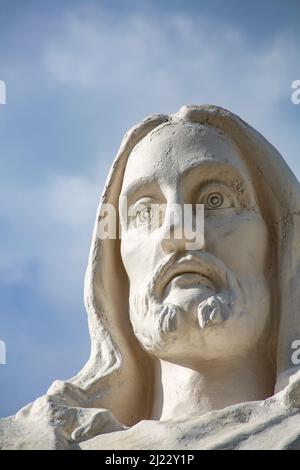 Cuzco, Peru - November 16, 2015: Statue of Jesus Christ in Peru under dark clouds. Stock Photo