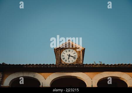 Old clock on the roof of a house Stock Photo