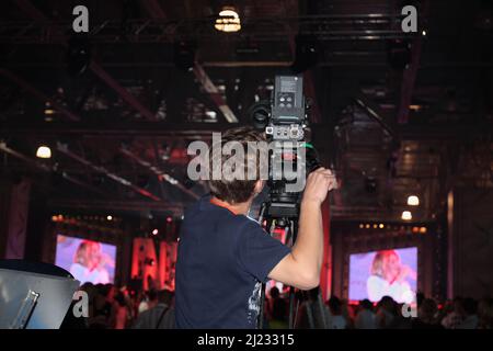 The videotape operator in makes a report about the nightclub Stock Photo