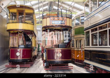 Derbyshire, UK – 5 April 2018: Beautifully restored vintage trams stored in the vehicle garage at Crich Tramway Village, the national tram museum Stock Photo