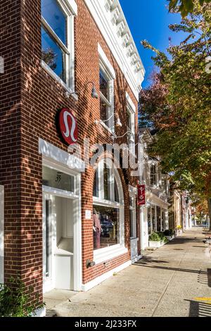 East Hampton, USA - October 27, 2015: view to Main street in East Hampton with old victorian wooden buildings on a sunny day. Stock Photo