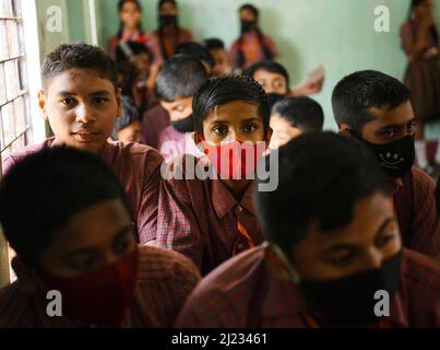 School students in the age group of 12 to 14 years waiting at a classroom to receive a dose of Corbevax Covid-19 preventive vaccine at a school. Agartala, Tripura, India. Stock Photo