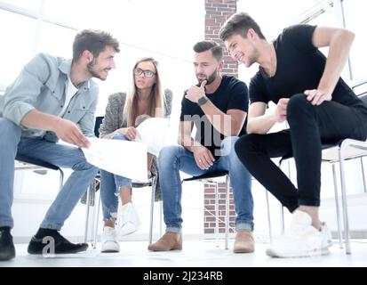 Business man passing over documents to leader during meeting Stock Photo