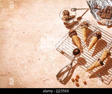 Chocolate ice cream on a metal rack with scoop from stainless steel with space for text, selective focus, close up Stock Photo