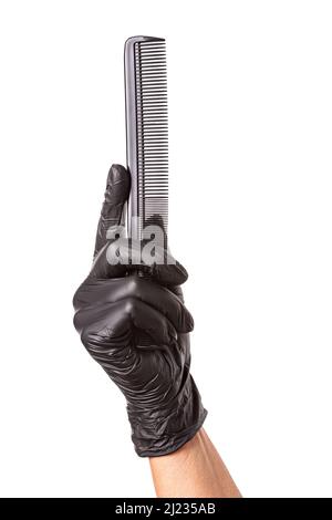 Hairdressers hand in black rubber glove holds a comb. Isolated on white background, close-up Stock Photo