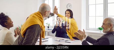 Team of happy business people celebrating success that they achieved with teamwork Stock Photo