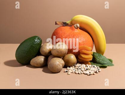 A set of natural products rich in Potassium. Organic potassium sources. Healthy food concept. Cardboard sign with the inscription.. Stock Photo