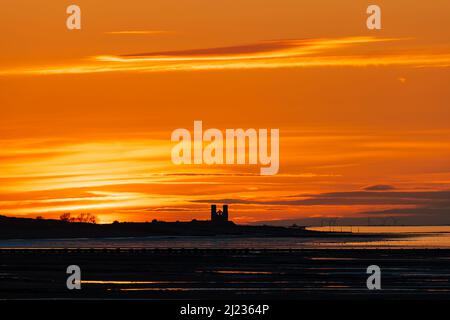 The twin towers of the ruined church of St Mary at Reculver, at sunset as seen from Birchington on Sea. Kent, England. Stock Photo