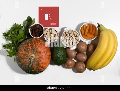 A set of natural products rich in Potassium. Organic potassium sources. Healthy food concept. Cardboard sign with the inscription.. Stock Photo