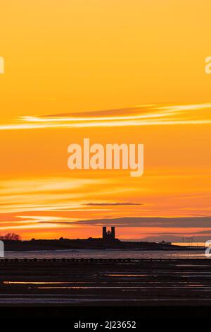 The twin towers of the ruined church of St Mary at Reculver, at sunset as seen from Birchington on Sea. Kent, England. Stock Photo