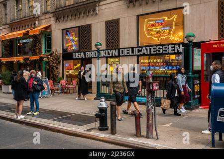 People walk past the USA Brooklyn Delicatessen in Midtown Manhattan in New York on Saturday, March 26, 2022.  The fast casual restaurant is part of the Fireman Hospitality Group. (© Richard B. Levine) Stock Photo