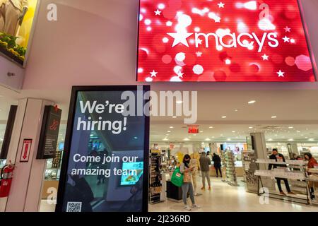 A sign inside Macy's flagship department store in Herald Square in New York informs potential employees of the job opportunities awaiting them during the annual Macy's Flower Show, on Sunday, March 27, 2021. (© Richard B. Levine) Stock Photo