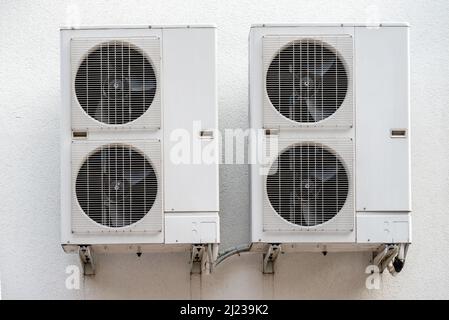 Air conditioner compressor outdoor unit installed outside the building Stock Photo