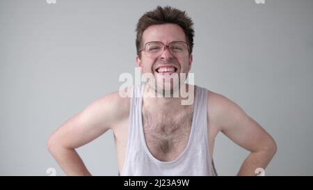 Funny young man in funny glasses laughing. Positive facial studio emotion. Stock Photo