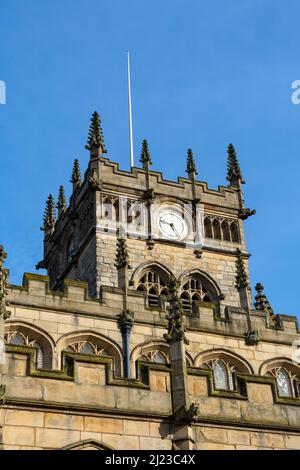 All Saints' Church, also known as Wigan Parish Church, with blue sky's behind.  Originally built in the 13th century with additions in the 16th and 17t Stock Photo