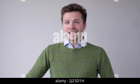 Cheerful young man smiling at camera. Studio shot Stock Photo