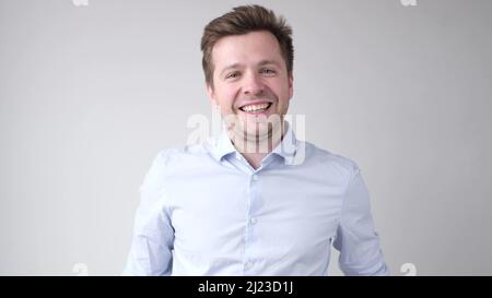 Cheerful young man smiling at camera. Studio shot Stock Photo