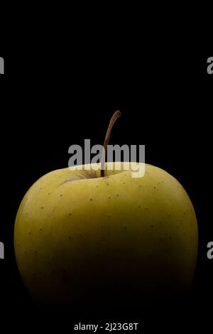 Macro photography of a green apple on a black background Stock Photo