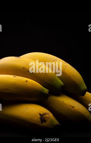 Macro photography of some bananas on a black background Stock Photo