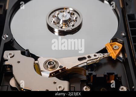 Mechanical parts of hard drive disk (HDD) inside a computer. Stock Photo
