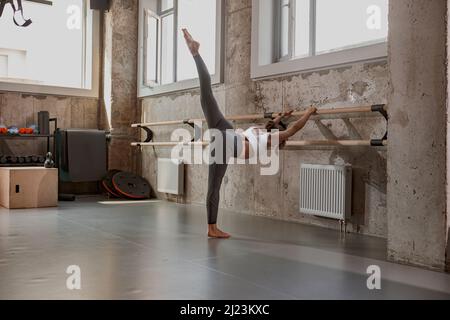 Good looking woman doing yoga pose in gym Stock Photo
