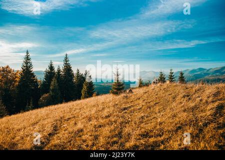 Horizontal shot of the rising sun and high mountains under the c Stock Photo