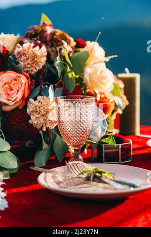 Amazing glass in boho style on the table of newlyweds Stock Photo