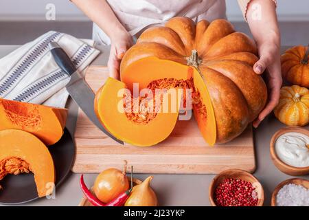 woman cooking orange butternut squash soup Stock Photo