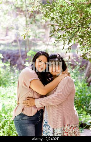 mother and daughter in jeans hug and smile Stock Photo - Alamy